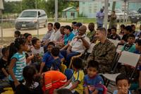 U.S. Army Lt. Col. Eldridge Singleton interact with students near Orange Walk, Belize