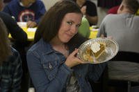 woman holding a piece of pie