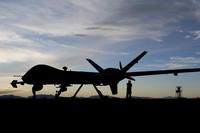 Airmen check over the first MQ-9 Reaper to be transported through ferry flight on Holloman AFB.