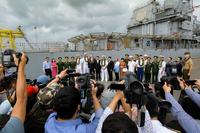 Vietnamese press photograph dignitaries at a press conference regarding the USS Theodore Roosevelt’s and the Ticonderoga-class guided-missile cruiser USS Bunker Hill’s arrival in Vietnam.