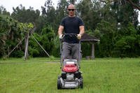 man pushing lawn mower