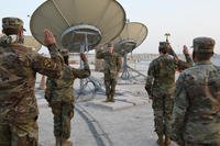 Col. Todd Benson, the U.S. Air Forces Central Command director of space forces, leads Airmen through their enlistment ceremony as they became members of the Space Force at Al Udeid Air Base, Qatar, on Sept. 1.