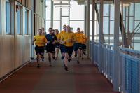 Sailors run on the indoor track on Fort Carson.