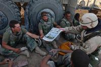 Command Sgt. Maj. John Sparks delivers copies of &quot;Stars and Stripes&quot; to Marines.