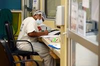 Army 1st Lt. Courtney Arthur, a registered nurse, checks patient records in the intensive care unit of Guam Memorial Hospital (GMH). (U.S. Navy/MacAdam Kane Weissman) Army 1st Lt. Courtney Arthur, a registered nurse, checks patient records in the intensive care unit of Guam Memorial Hospital (GMH).