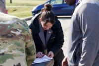 A clerk checks in Wisconsin National Guard members mobilized to serve as poll workers in Madison.