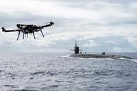 A UAV delivers a payload to the Ohio-class ballistic-missile submarine USS Henry M. Jackson.