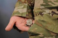 A U.S. Army soldier holds out her pocket change.