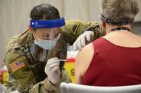 Member of the Oregon Army National Guard administers the COVID-19 vaccine.