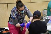 A Montana VA nurse administers the Moderna vaccine to a veteran.