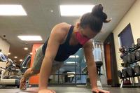 Senior Airman  holds the push-up portion for her mock Air Force Physical Training Test.