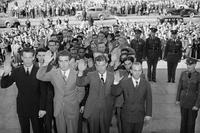 Eight men raise their right hands as they are sworn into the Army in 1940.