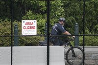 A U.S. Capitol Police officer patrols the barricaded perimeter of the Capitol.