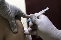 A man receives a shot of COVID-19 vaccine in Afghanistan.