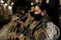 Airmen await takeoff in a C-17 Globemaster III