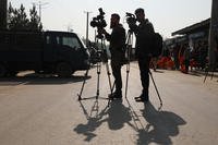 Afghan journalists film at the site of a bombing attack in Kabul, Afghanistan