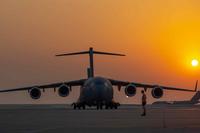 C-17 Globemaster lll as another C-17 taxis at Al Udeid Air Base, Qatar.