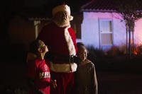 Children take photo with Santa Claus during Operation Santa Claus.