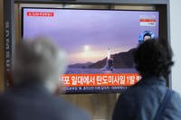 TV screen showing a news program reporting about North Korea's missile launch