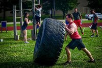 Airman flips tire during Murph workout.