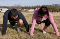 Taylor Mungie and Ashli Arrisola stretch before the Trails of Hope 5K run.