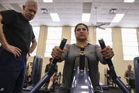 An airman exercises on a seated row machine.