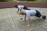 Airmen perform push-ups at the Pittsburgh airport.