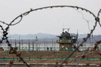 South Korean army soldiers patrol along the barbed-wire fence in Paju, near the border with North Korea