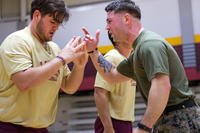 A Marine reservist motivates a member of the Loyola University baseball team.