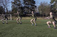 Students belonging to the North Carolina Piedmont Region Consortium NROTC Unit participate in an instructor-led workout session.