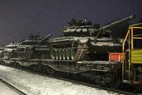 Russian army tanks are loaded onto railway platforms.