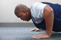 A senior airman completes one minute of traditional push-ups during a physical fitness test.