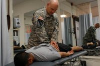 A soldier is checked for lower-back pain at Fort Hood.