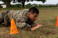 A Marine low-crawls during a combat fitness test on Keesler Air Force Base, Mississippi.