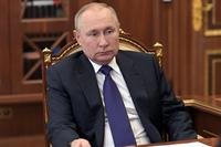 Russian President Vladimir Putin listens to St. Petersburg's governor Alexander Beglov.