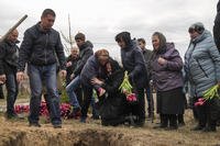 A grandmother cries during a funeral ceremony in L'giv village, Chernihiv region, Ukraine.