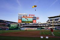 The U.S. Army Parachute Team the Golden Knights descend into National Park before a baseball game