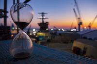 A sand timer rests on a scaffold board of the USS George Washington,