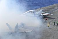 An E/A-6B Prowler pours smoke from its exhaust.