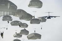 Army paratroopers jump from a C-17 Globemaster III in Alaska.