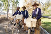 Reenactors are shown with replica bicycles and uniforms for the 25th Infantry Regiment Bicycle Corps.