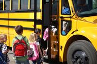 Children board a school bus at Schriever Air Force Base.