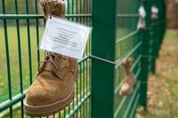 A wall of boots represents individuals effected by sexual harassment.