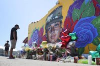 People look at a mural of slain Army Spc. Vanessa Guillen.