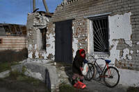  elderly woman receives a food at a mobile humanitarian aid point in the village of Zarichne, Donetsk region, Ukraine