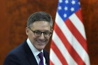U.S. State Department Counselor Derek Chollet smiles ahead of a meeting