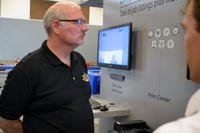 Retired Sgt. 1st Class Craig Snitker looks on as a Hero2Hired representative explains functions of the program’s new website prior to an H2H job fair.