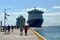 Two cruise ships sit docked in Mexico.