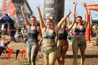 Participants at the Tough Mudder obstacle course celebrate crossing the finish line.