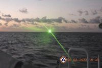 green military-grade laser light from a Chinese coast guard ship in the disputed South China Sea